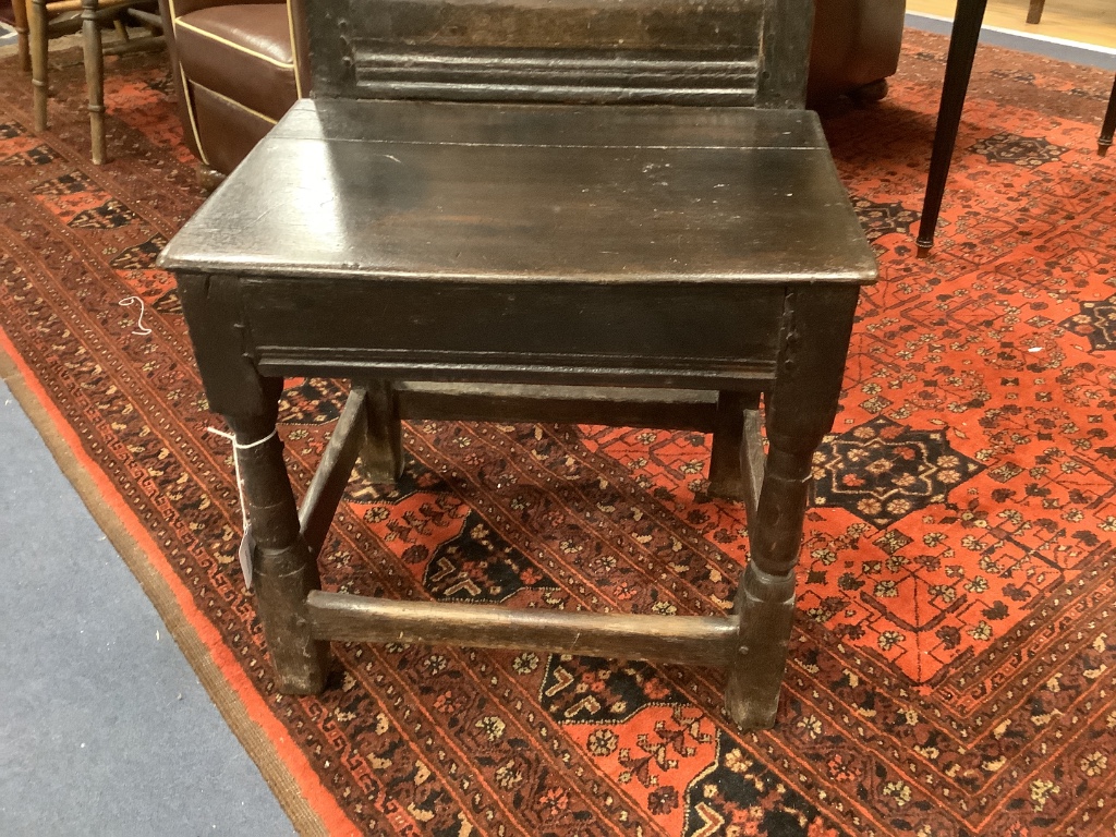 A 17th century and later oak panelled back stool with carved lozenge decoration, width 47cm, depth 38cm, height 91cm